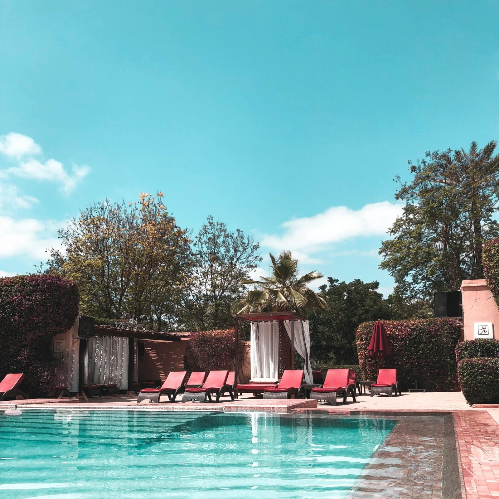A relaxing poolside view at a tropical resort, a type of vacation stay available with hotel booking deals on GlobalTravelGuideX.